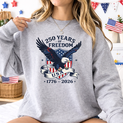Person wearing a gray sweatshirt with an eagle design and text celebrating 250 years of freedom.