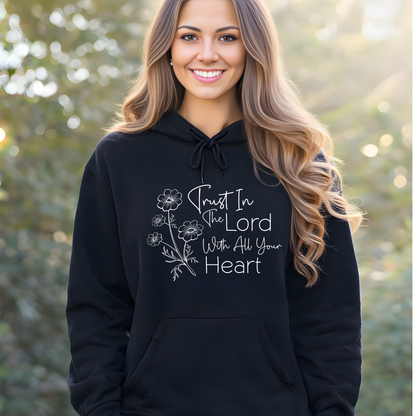 Woman wearing a black hoodie with a motivational quote outdoors