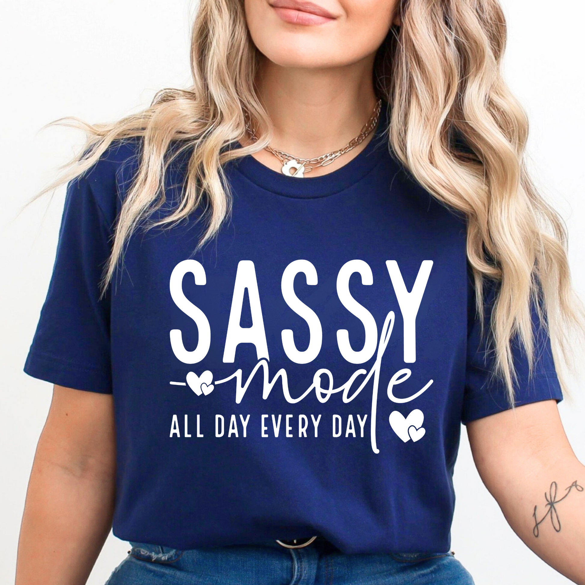 Woman wearing a navy blue t-shirt with 'SASSY mode ALL DAY EVERY DAY' text.