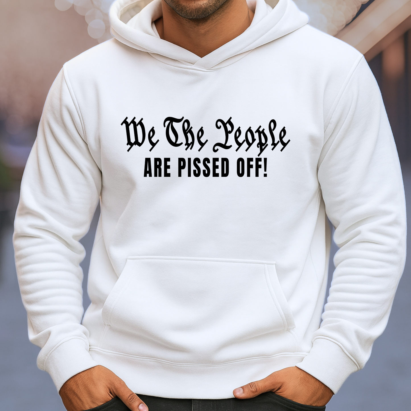 White hoodie with text 'We The People ARE PISSED OFF!' worn by a man.