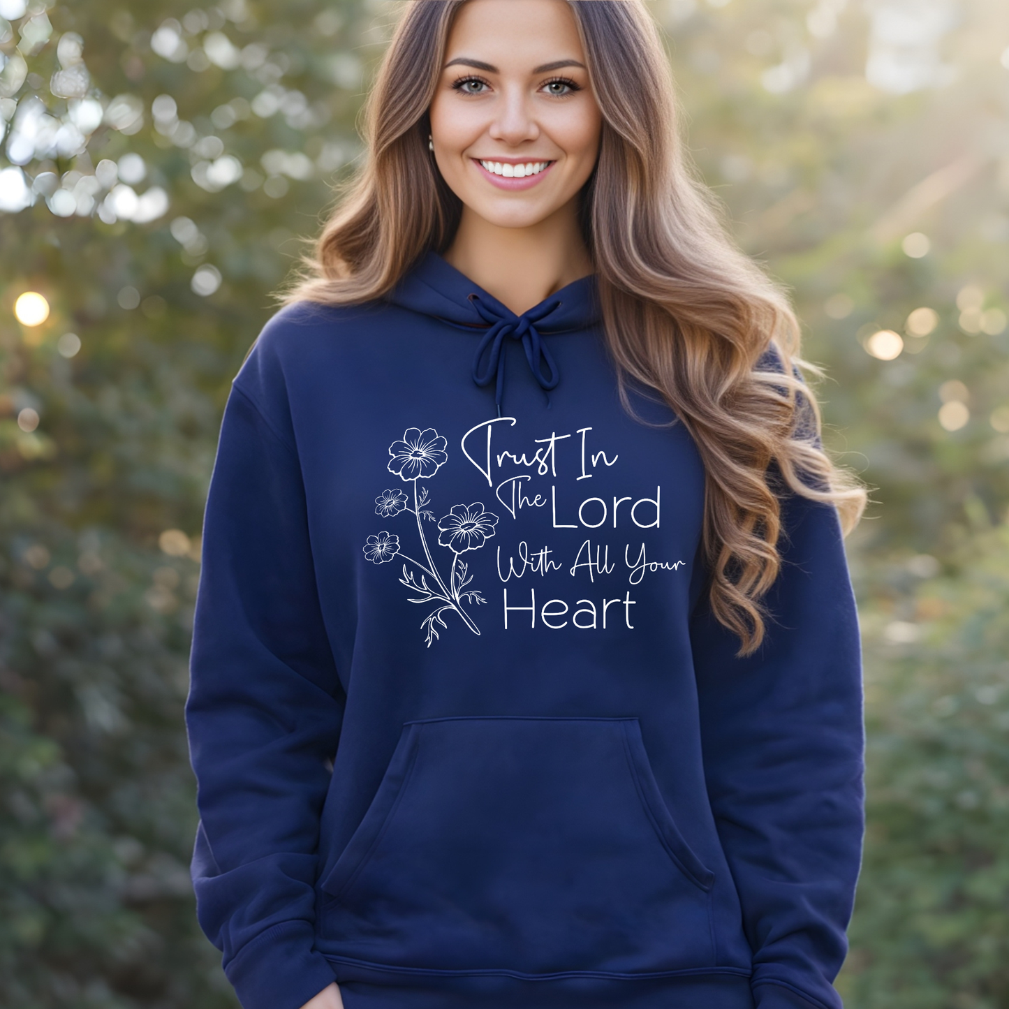 Woman wearing a navy blue hoodie with a motivational quote outdoors