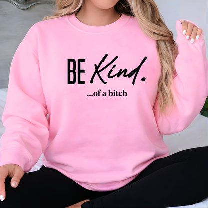 Pink sweatshirt with 'BE KIND. ...of a bitch' text worn by a person.