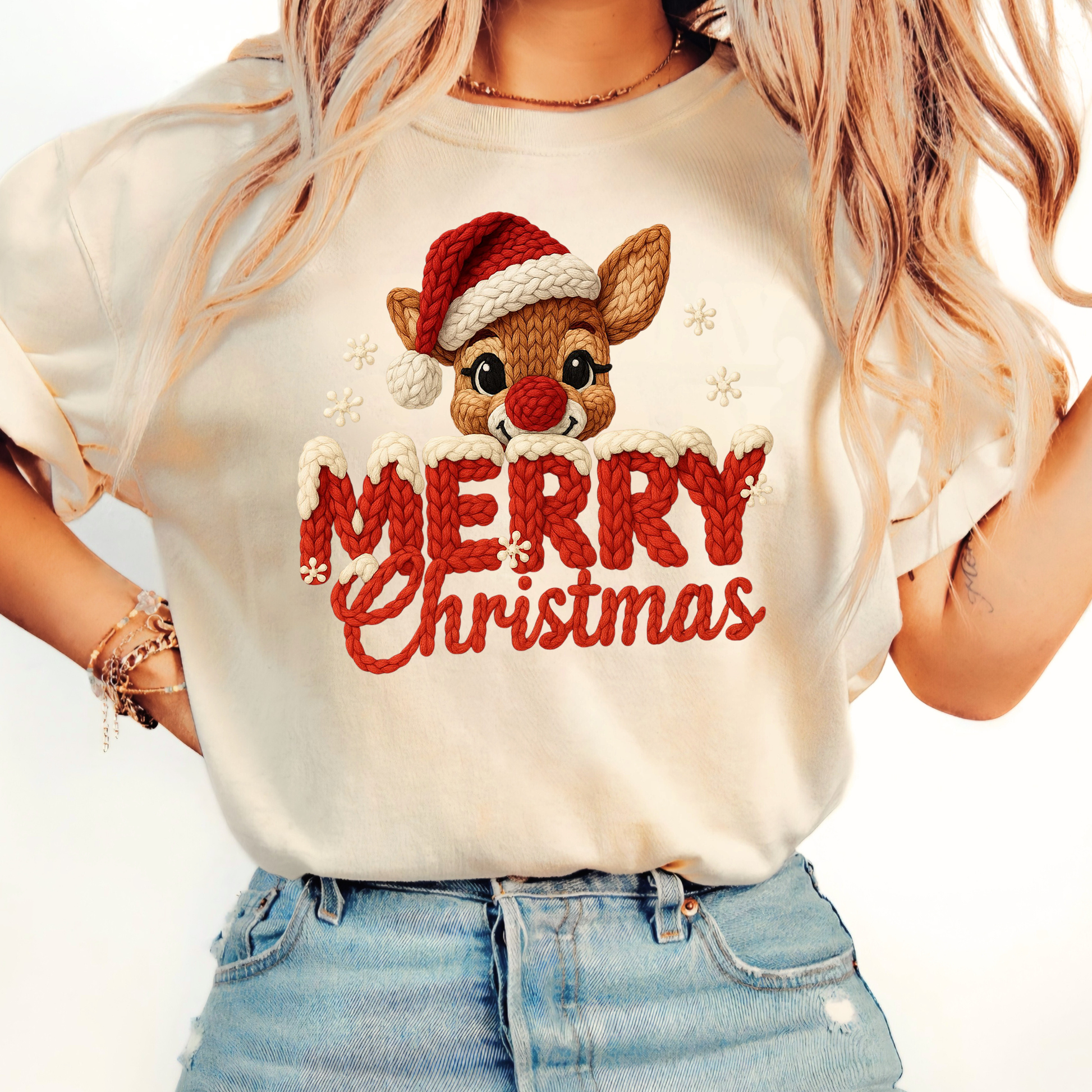 Sand beige T-shirt with faux crochet Merry Christmas reindeer design worn by woman with denim shorts