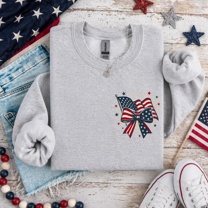 Gray sweatshirt with a patriotic design on a wooden surface with American flags and jeans.