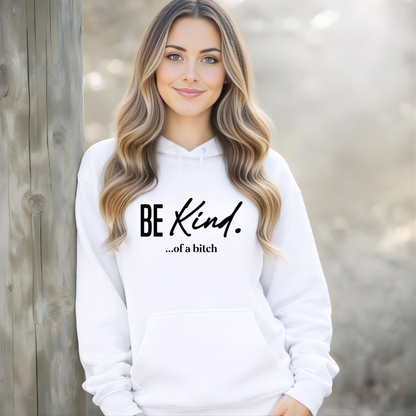 Woman wearing a white hoodie with 'BE KIND. . .of a bitch' text.