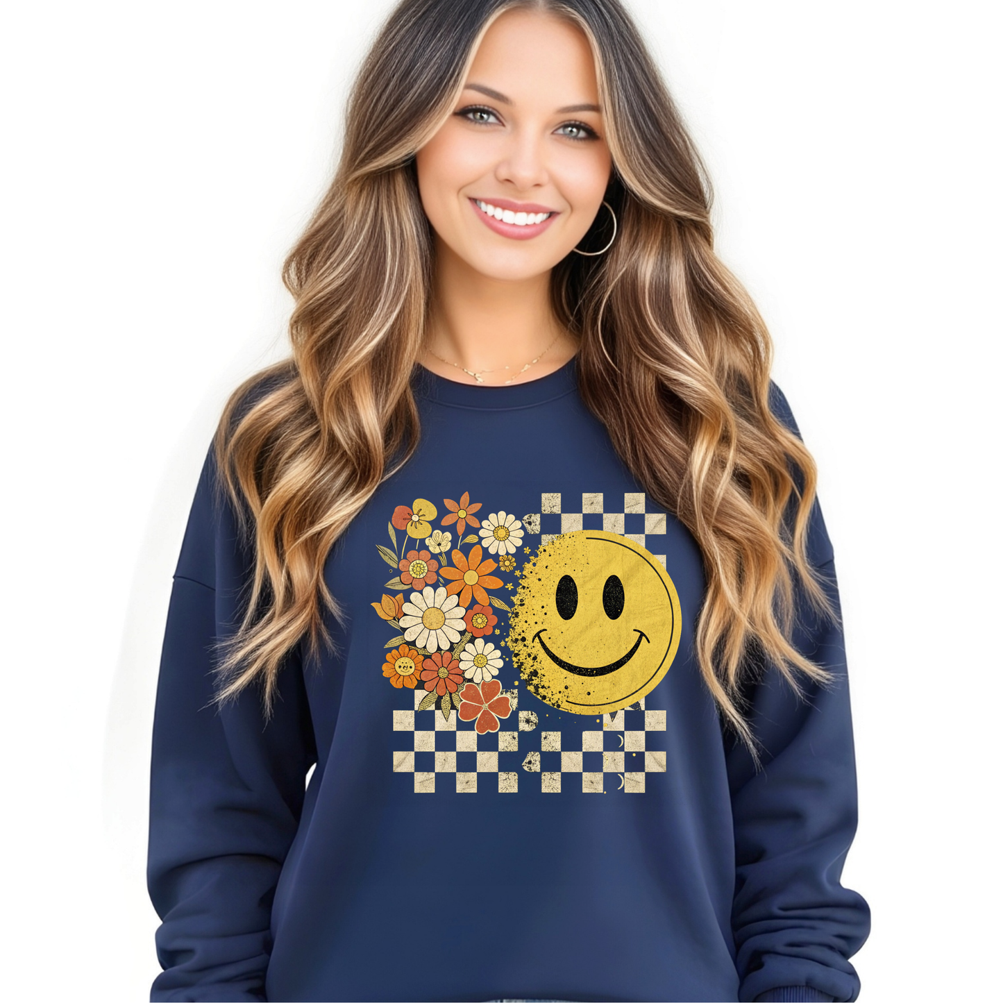 Woman wearing a navy blue sweatshirt with a vintage smiley face and floral design on a white background