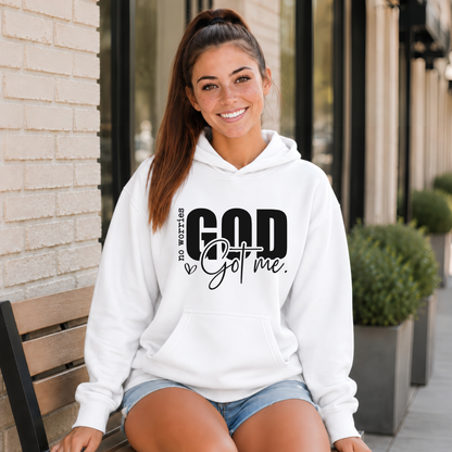 Woman wearing a white No Worries God Got Me hoodie with bold black graphic lettering outside a storefront.