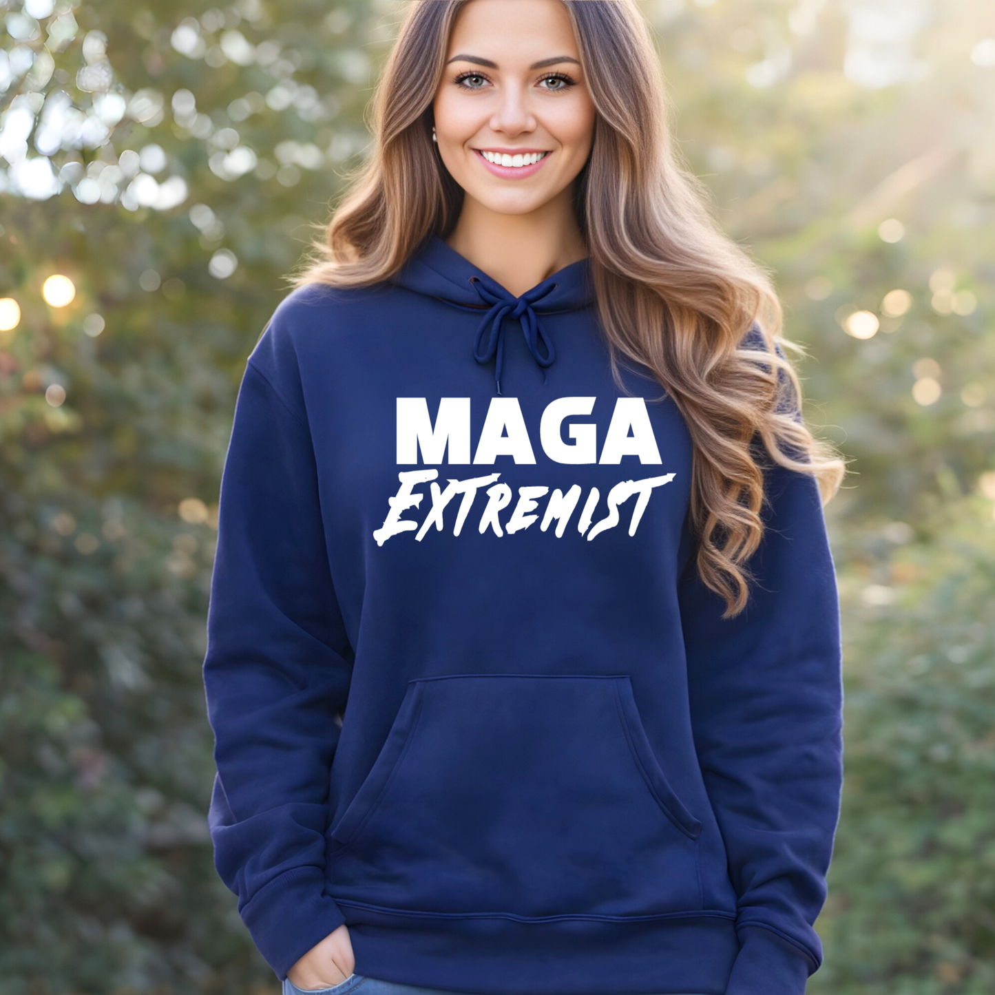 Person wearing a blue hoodie with 'MAGA Extremist' text outdoors.