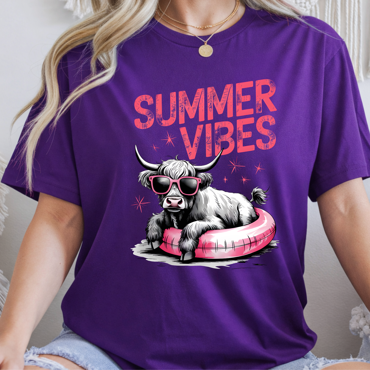 Purple t-shirt with a cow graphic and 'Summer Vibes' text, worn by a person.