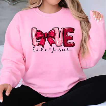 Pink sweatshirt with 'Love like Jesus' text and red bow graphic
