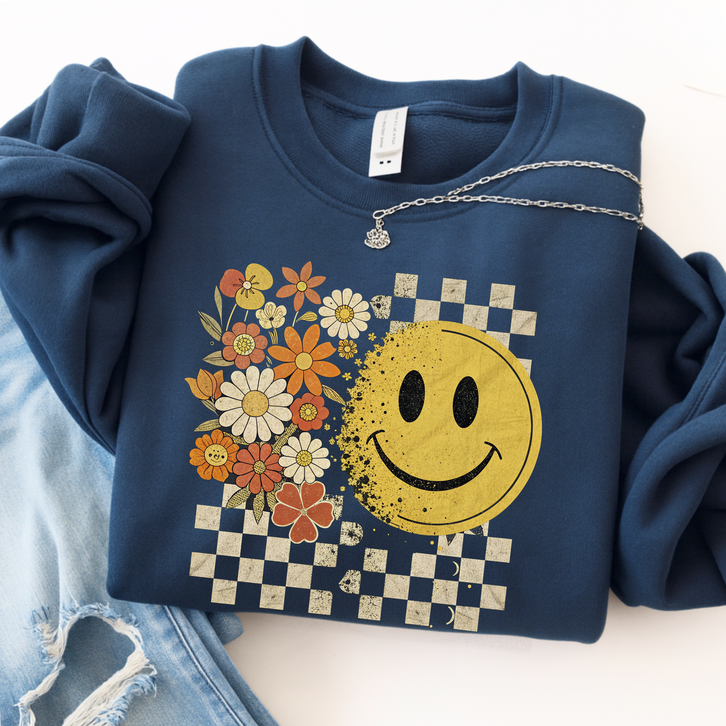 Navy blue sweatshirt with smiley face and floral design on a white background