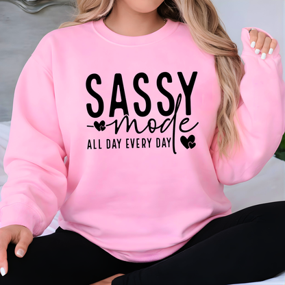 Pink sweatshirt with 'Sassy mode all day every day' text