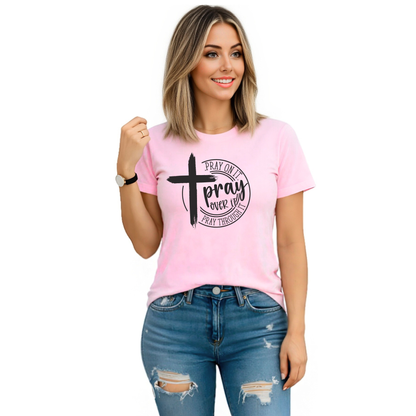 Woman wearing a pink t-shirt with a cross and text design on a white background