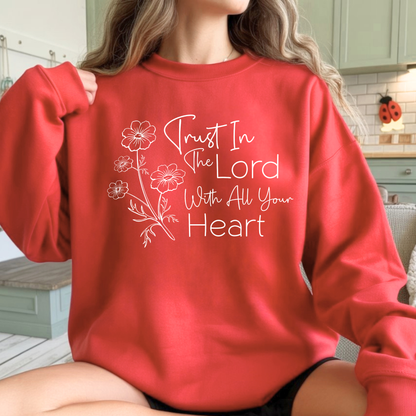 Person wearing a red sweatshirt with 'Trust In The Lord With All Your Heart' text and floral designs.