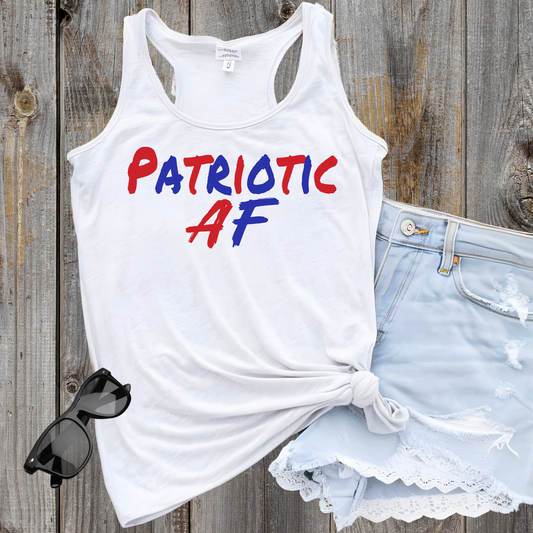 Flat lay white racerback tank top tied at waist with "Patriotic AF" red and blue graphic.

