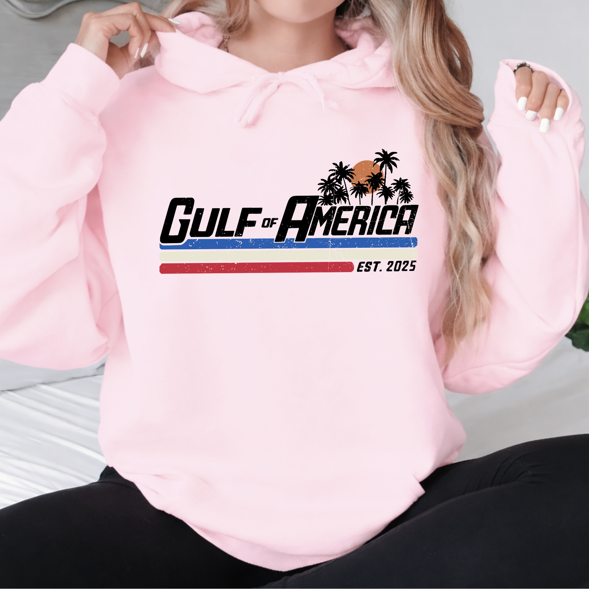 Pink hoodie with 'Gulf of America' design worn by a person
