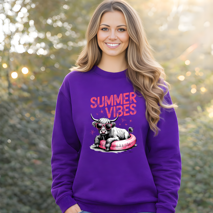 Woman wearing a purple sweatshirt with 'Summer Vibes' and a highland cow graphic, standing outdoors.