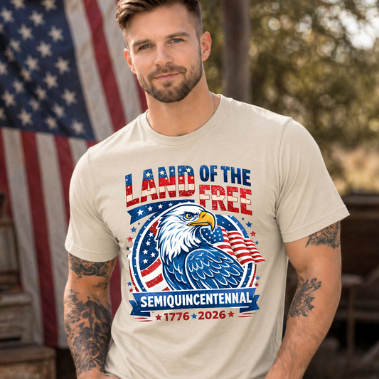 Man wearing a t-shirt with 'Land of the Free' design in front of an American flag.