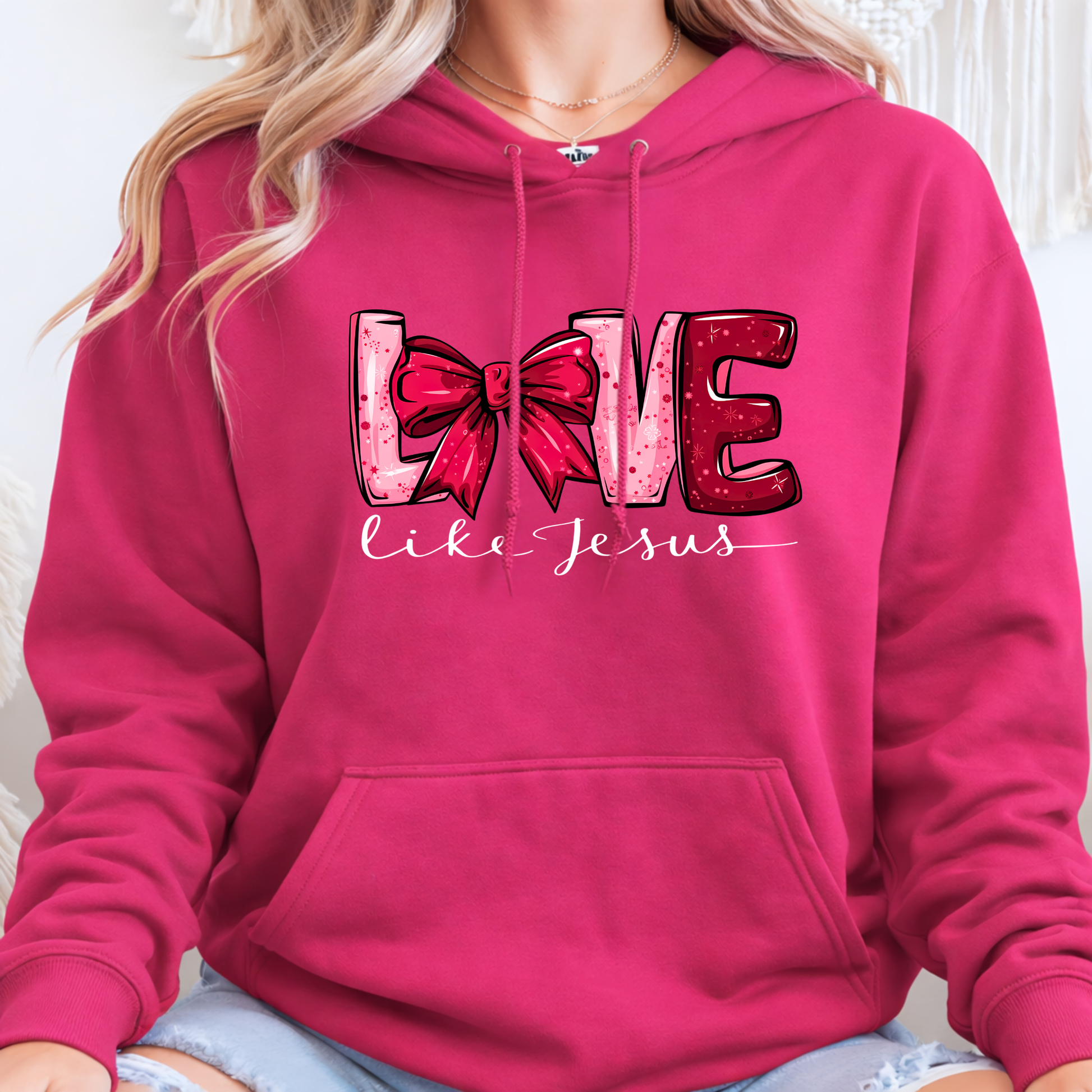 Pink hoodie with 'Love like Jesus' design featuring a red bow