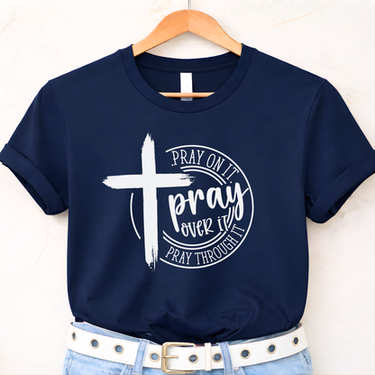 Navy blue t-shirt with a white cross and text on a hanger against a white background