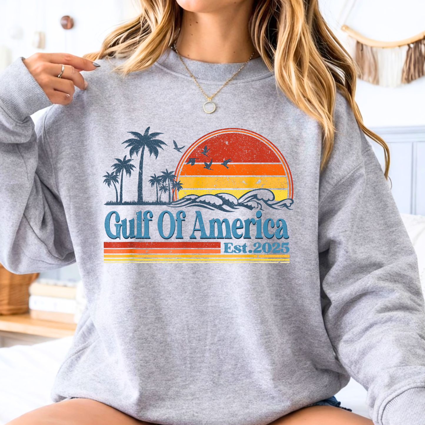 Woman wearing a gray sweatshirt with 'Gulf of America' design