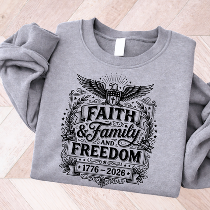 Gray sweatshirt with 'Faith & Family & Freedom' design on a wooden surface