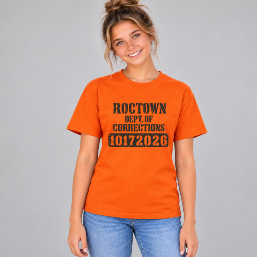 Front of an orange Roctown player T-shirt with worn black Dept. of Corrections lettering and the number 10172026.