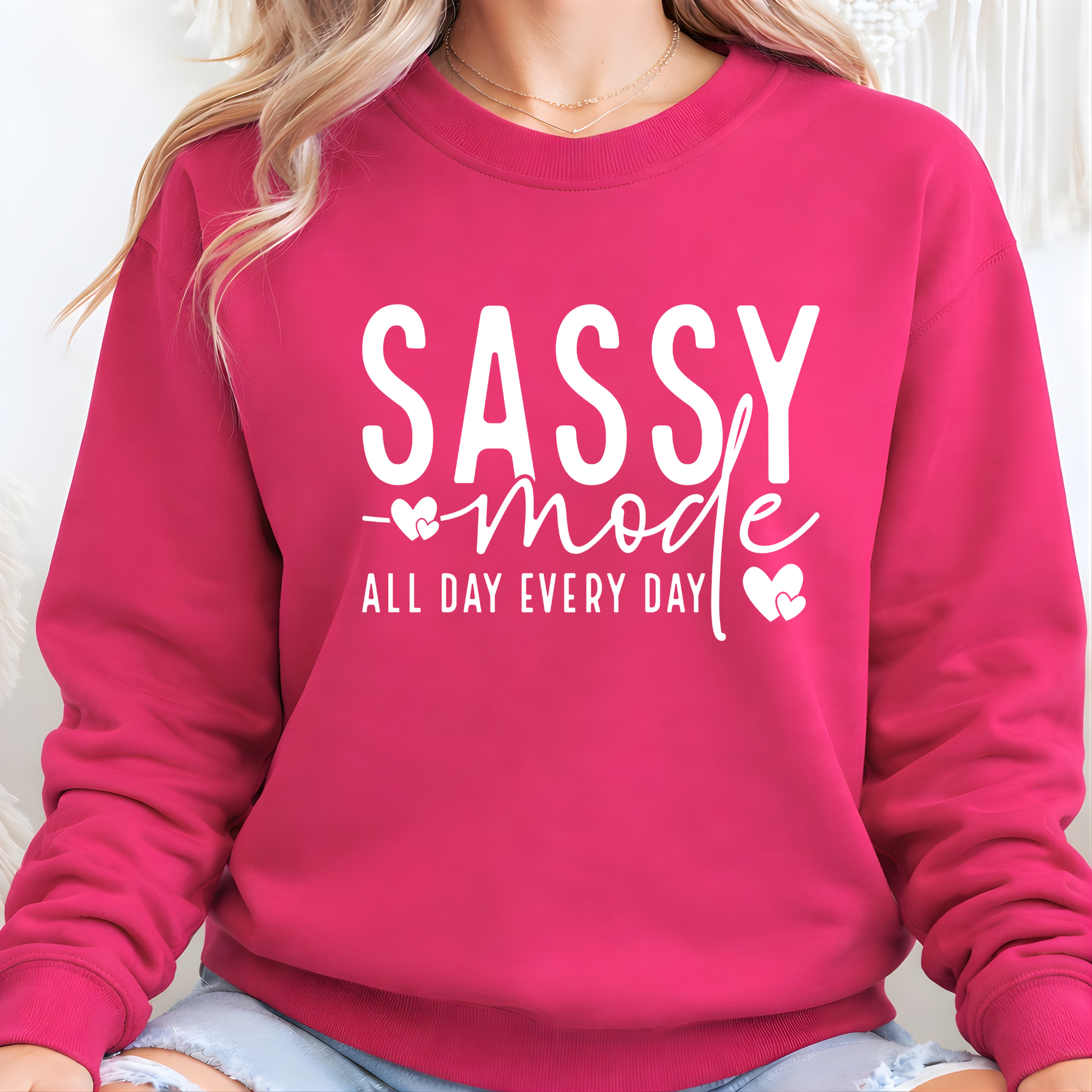 Pink sweatshirt with 'SASSY mode ALL DAY EVERY DAY' text on a white background