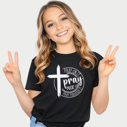 Young Girl wearing a black t-shirt with a cross and text design, making peace signs.