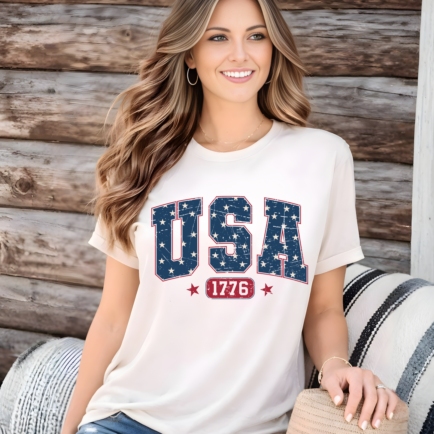 Woman wearing a America 250 USA 1776 patriotic t-shirt in sand beige, distressed American flag lettering, celebrating 250 years of freedom