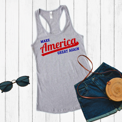 gray MAGA tank top with bold red America script and blue text laid flat on neutral surface