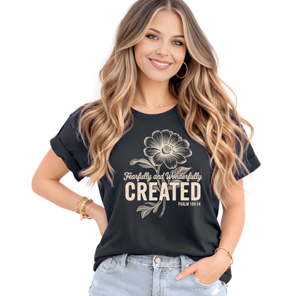 Woman wearing a black t-shirt with a floral design and text on a white background