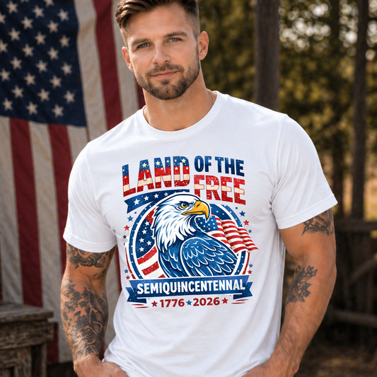Man wearing a white America 250 t-shirt with an eagle graphic and text in front of an American flag.
