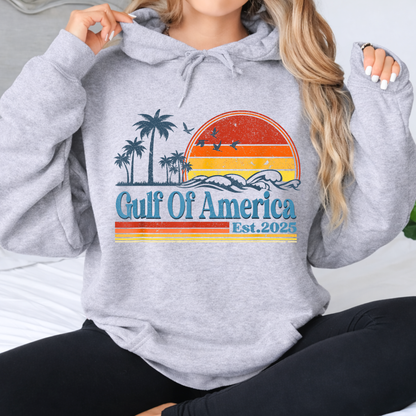 Woman wearing a gray hoodie with 'Gulf Of America' design