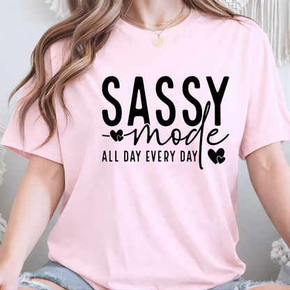 Woman wearing a pink t-shirt with 'Sassy mode all day every day' text.