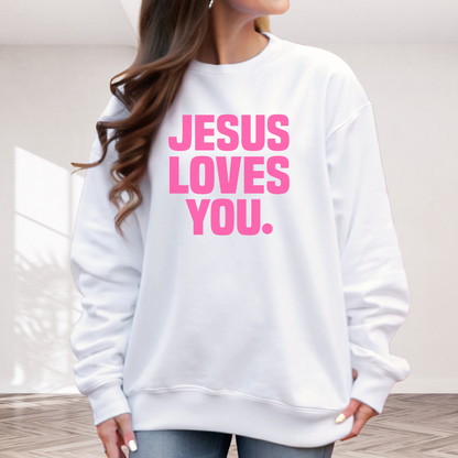 White sweatshirt with 'Jesus Loves You' text in pink on a neutral background