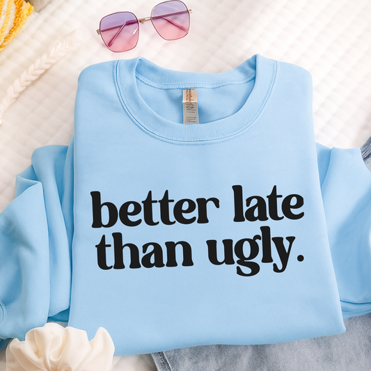 Light blue sweatshirt on hanger with bold better late than ugly text