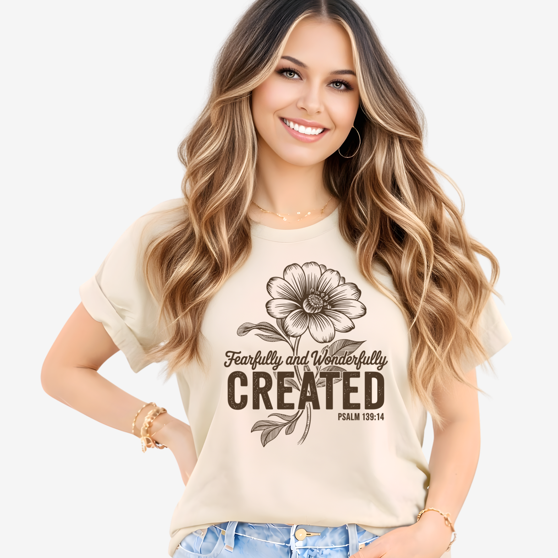 Woman wearing a beige t-shirt with a  Christian floral design and text on a white background