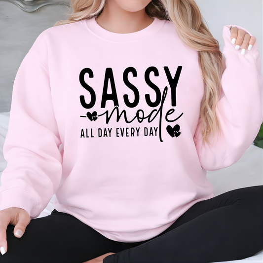 Woman  wearing a pink sweatshirt with 'Sassy mode all day every day' text.