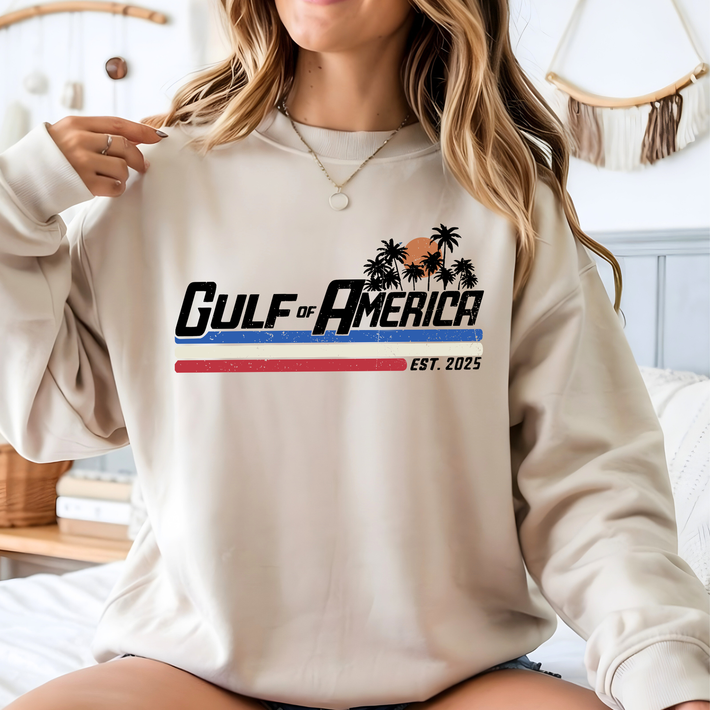 Person wearing a beige sweatshirt with 'Gulf of America' design