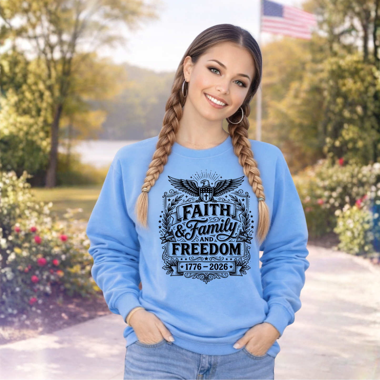 Woman wearing a blue sweatshirt with 'Faith & Family & Freedom' text in a park setting.