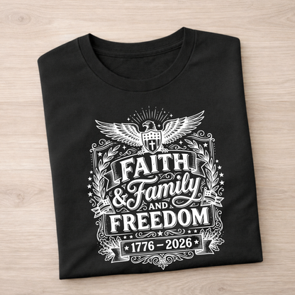 Black t-shirt with white Faith, Family, Freedom graphic design featuring text and an eagle on a wooden surface