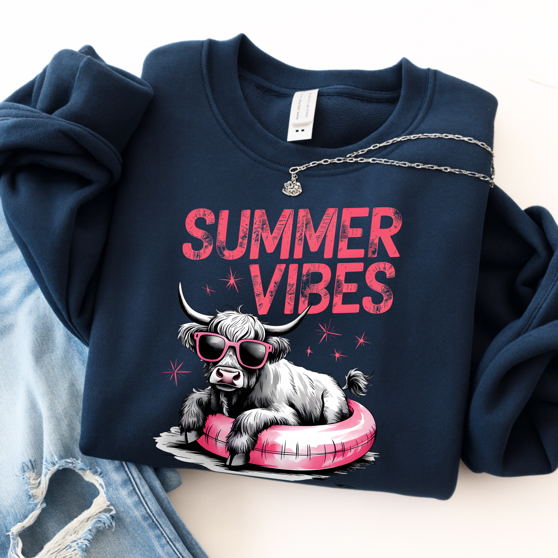 Navy blue sweatshirt with 'Summer Vibes' text and cow graphic on a light background