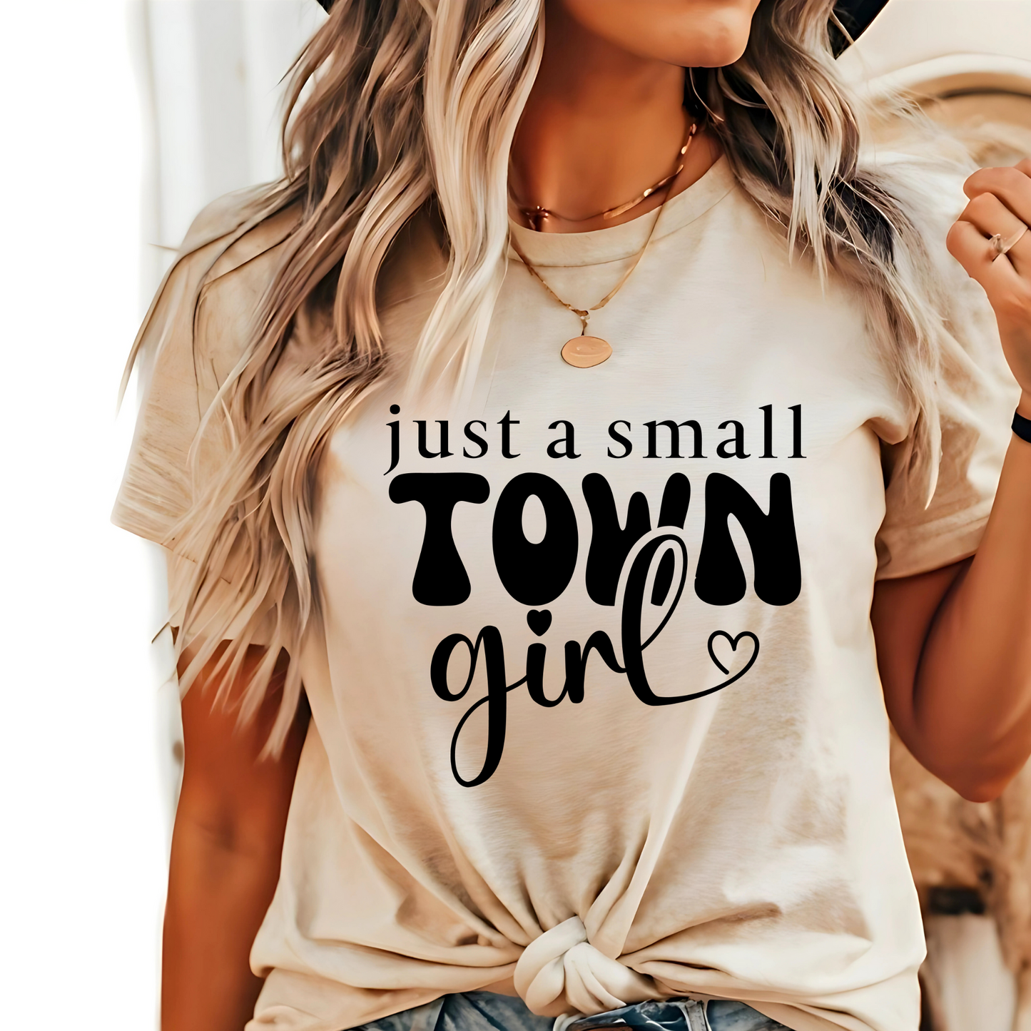 Close-up of black text graphic on a beige country-style T-shirt.