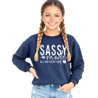 Girl wearing a navy blue sweatshirt with 'Sassy mode all day every day' text on a white background