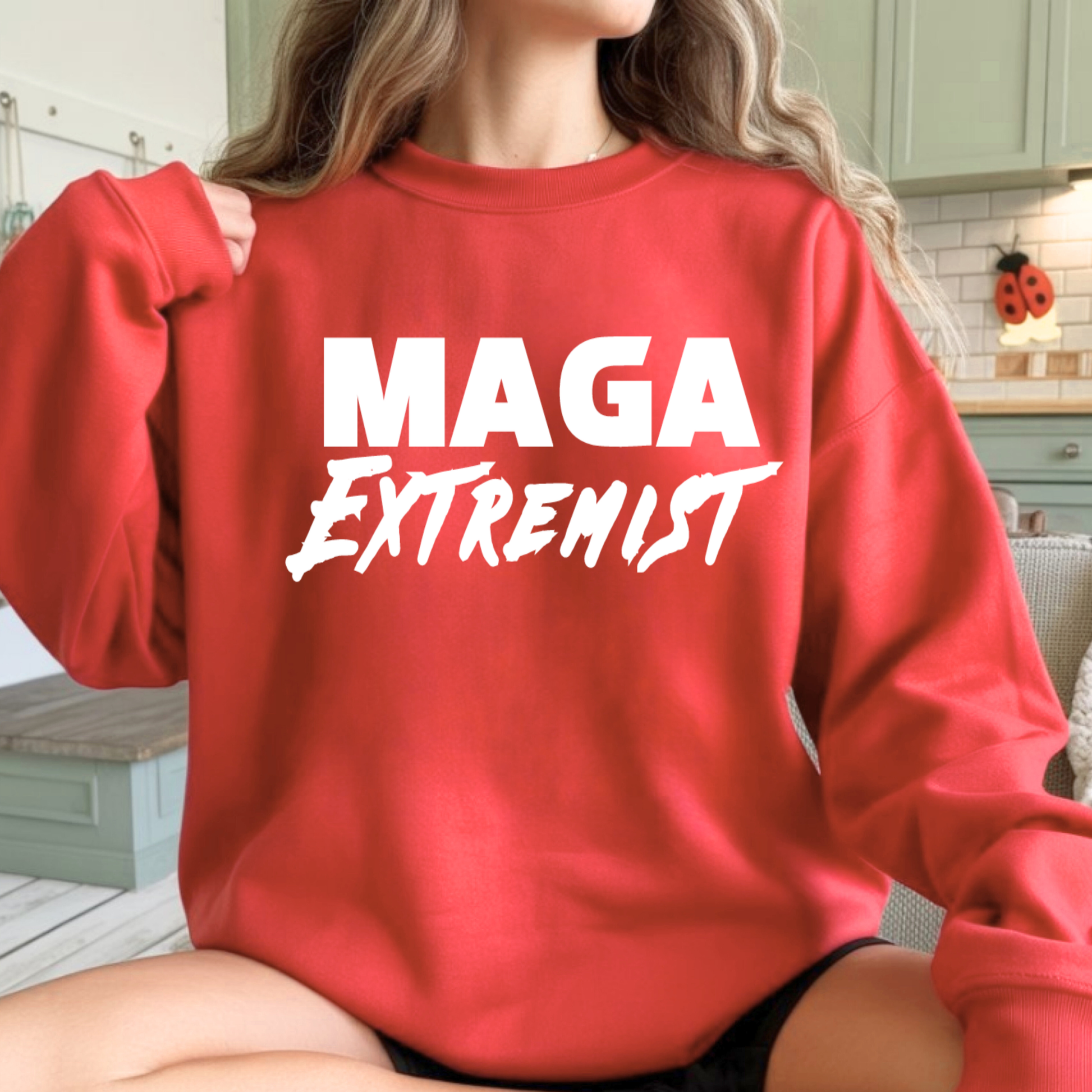 Woman wearing red MAGA Extremist crewneck sweatshirt, relaxed oversized fit