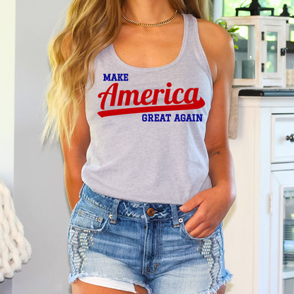 Young woman showing off a gray Make America Great Again racerback tank top in a casual outdoor setting