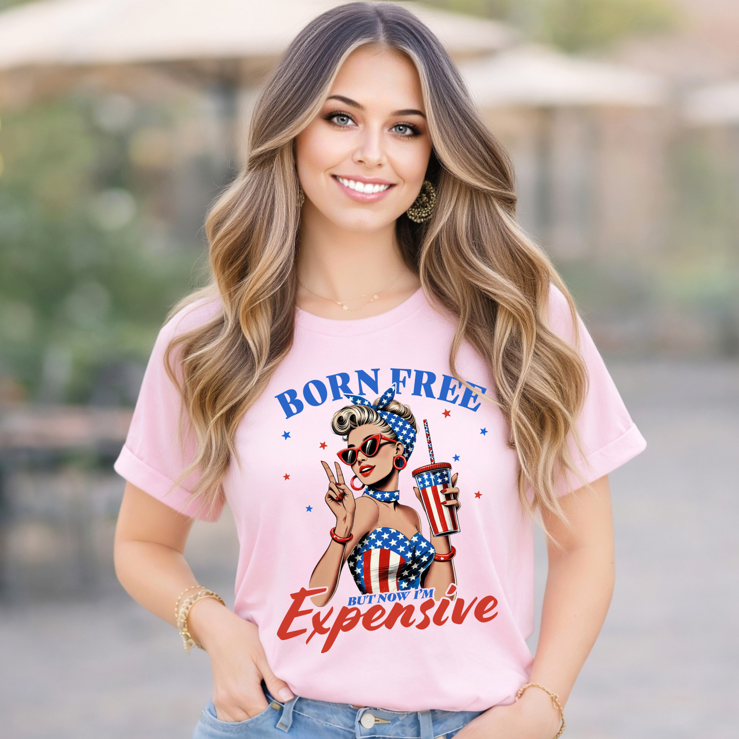 Woman wearing a pink "Born Free but now Im expensive Tshirt.