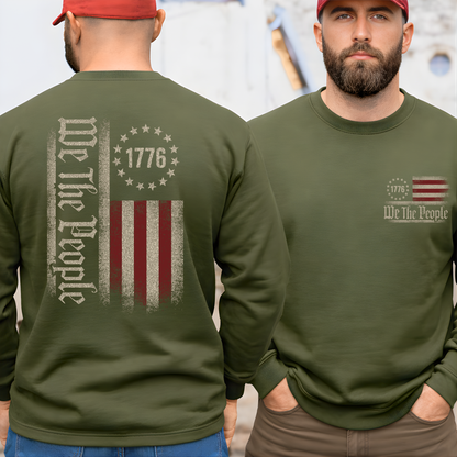 Man wearing a green long-sleeve shirt with 'We The People' and 1776 design on the front and back.