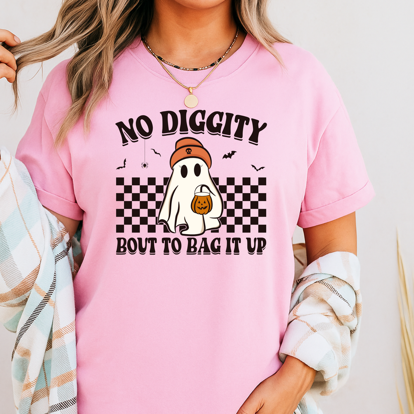 Person wearing a pink t-shirt with a ghost graphic and text.